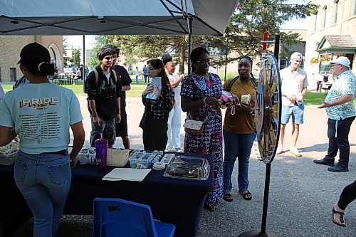 BU students spin the wheel to win prizes during Orientation Day on Tuesday. (Abiola Odutola/The Brandon Sun)