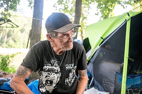 MIKAELA MACKENZIE / WINNIPEG FREE PRESS

Encampment resident Terry Johnsen talks to the Free Press while separating metal for recycling at Fort Rouge Park on Tuesday, Sept. 3, 2024. A police vehicle hit a woman, who later died of her injuries, on their way down to the encampment last night.

For Nicole story.
Winnipeg Free Press 2024