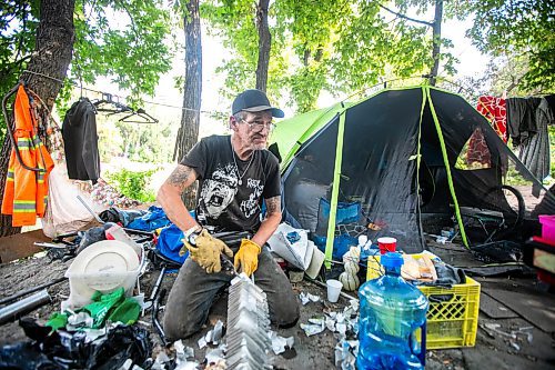 MIKAELA MACKENZIE / WINNIPEG FREE PRESS

Encampment resident Terry Johnsen talks to the Free Press while separating metal for recycling at Fort Rouge Park on Tuesday, Sept. 3, 2024. A police vehicle hit a woman, who later died of her injuries, on their way down to the encampment last night.

For Nicole story.
Winnipeg Free Press 2024