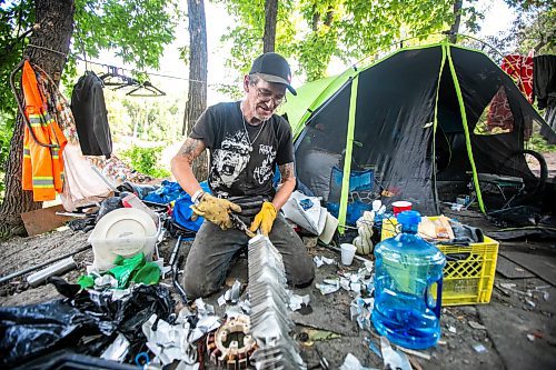 MIKAELA MACKENZIE / WINNIPEG FREE PRESS

Encampment resident Terry Johnsen talks to the Free Press while separating metal for recycling at Fort Rouge Park on Tuesday, Sept. 3, 2024. A police vehicle hit a woman, who later died of her injuries, on their way down to the encampment last night.

For Nicole story.
Winnipeg Free Press 2024