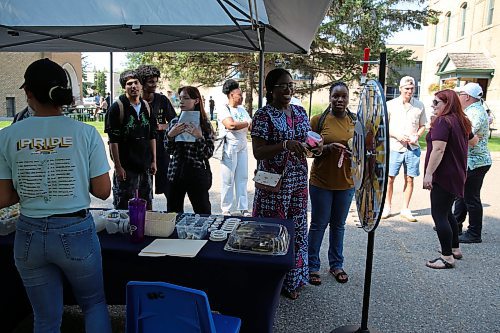 BU students spin the wheel to win prizes during Orientation Day on Tuesday. (Abiola Odutola/The Brandon Sun)