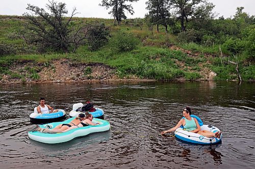 22072024
Friends Luis Alvarenga, Cassandra Kowalchuk, Jodie Tocher and Loren Lobreau float down the Little Saskatchewan River west of Brandon on a hot and humid Monday afternoon. 
(Tim Smith/The Brandon Sun)