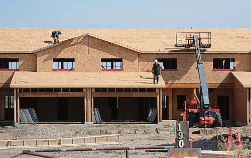 A construction crew works on a new residential development on First Street near Crocus Plains Regional Secondary School on Wednesday afternoon. (Matt Goerzen/The Brandon Sun)