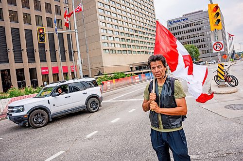 NIC ADAM / FREE PRESS
Protester David Ferland blocks traffic in the intersection of Portage and Main early Wednesday afternoon after Tammy Bateman was struck and killed by a police vehicle at a homeless encampment.
240904 - Wednesday, September 04, 2024.

Reporter: Nicole