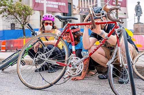 NIC ADAM / FREE PRESS
A protester and Critical Mass Winnipeg member was struck with her bike when a man drove his vehicle through the protest blocking traffic at Portage and Main on Wednesday about 20 minutes after it began.
240904 - Wednesday, September 04, 2024.

Reporter: Nicole
