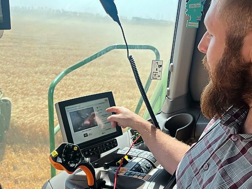 Much of a combine's operation is now automated, and includes video cameras inside the hopper, providing a visual for the combine operater inside the cab &#x460;in this case, Neil Waldner of Hillside Hutterite Colony on Wednesday afternoon in a field north of Brandon. (Matt Goerzen/The Brandon Sun)