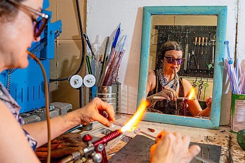 NIC ADAM / FREE PRESS
Glass worker Brook Drabot pictured blowing glass in the garage studio of her Warren home Friday. Brook loves making very small things, blowing glass to create tiny vases, miniature ornaments and small bowls. 
240801 - Thursday, August 01, 2024.

Reporter: