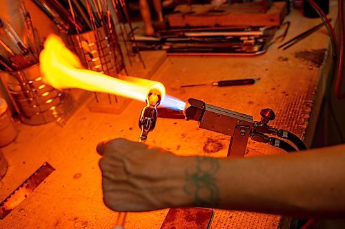 NIC ADAM / FREE PRESS
Glass worker Brook Drabot pictured blowing glass in the garage studio of her Warren home Friday. Brook loves making very small things, blowing glass to create tiny vases, miniature ornaments and small bowls. 
240801 - Thursday, August 01, 2024.

Reporter: