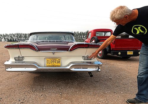 Gord Falk points to the letter 'E' that is in the turn signal light on his 1958 Ford Edsel Corsair, a car that was produced by the Ford Motor Company and only sold for two years, 1958 and 1959. (Michele McDougall/The Brandon Sun)