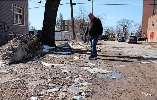 TYLER SEARLE  / WINNIPEG FREE PRESS

Take Pride Winnipeg executive director Tom Ethans walks along litter on the corner of Charles Street and Selkirk Avenue.
Ethans says this was be a level 4 on the litter index.
April 27, 2022