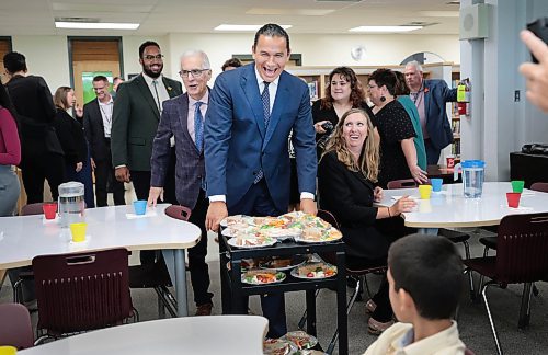 Manitoba Premier Wab Kinew and Education Minister Nello Altomare hand out free lunches to students on Thursday at Donwood School in Winnipeg to launch the province's school nutrition program. (Ruth Bonneville/Winnipeg Free Press)