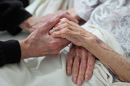 RUTH BONNEVILLE / WINNIPEG FREE PRESS 

LOCAL - Family run home care

Photo of Raymond Duerinckx, 87, holding the hands of his wife Tanis of over 60 years as he and his daughter care for her at home after heart failure. 

Story: Raymond Duerinckx, 87, and his daughter Michelle Duerinckx are looking after their wife and mother who is on palliative care at home for heart failure. She will be 90 in a few days. They had to obtain private home care, partly covered out of pocket, because Tannis never got the consistent home care services she needed upon being released from the hospital. The private costs are partially funded under the province's self-management care program, but Raymond spends over $1000 every two weeks to keep the private care. Meanwhile, Michelle cares for her mother all night and works as a home-care worker during the day. 



Feb 24th,  2023