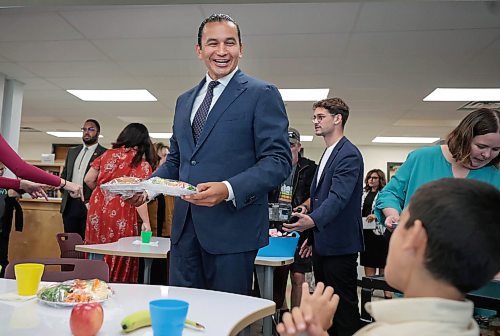 Manitoba Premier Wab Kinew and Education Minister Nello Altomare hand out a free lunch to students as the province launched a new school nutrition program on Thursday. (Ruth Bonneville/Winnipeg Free Press)