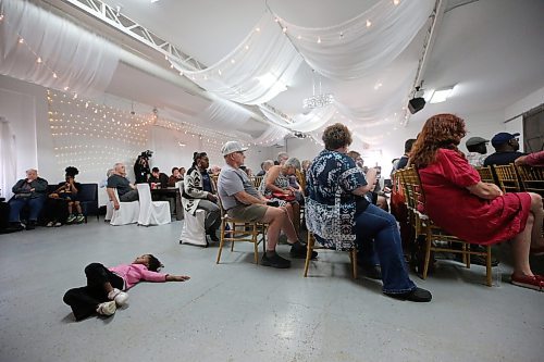 A bored child entertains herself on the floor during a public townhall meeting with Brandon Mayor Jeff Fawcett and Brandon East MLA Glen Simard on Thursday evening at The Backyard on Aberdeen. (Matt Goerzen/The Brandon Sun)