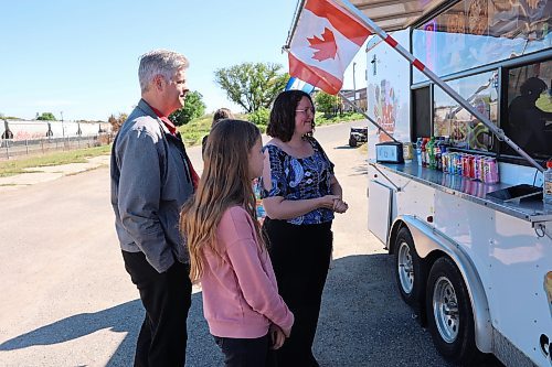 Left; Patrick Loewen, his daugther, Olivia, and wife, Ruth, wait for their orders by the Delicious Catrachos food truck during the last day of the Downtown Summer Market Friday afternoon. WIS representative Ruth Loewen says the market exceeded initial expectations, "It's been really, really good. We've been having upwards of 300 people per day.” (Abiola Odutola/The Brandon Sun)