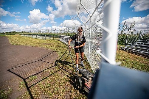 MIKAELA MACKENZIE / WINNIPEG FREE PRESS

Claire McKay trims the grass at the edges of the Field of Dreams baseball diamond near Clearwater, Manitoba on Thursday, Sept. 5, 2024. 

For Mike McIntyre story.
Winnipeg Free Press 2024