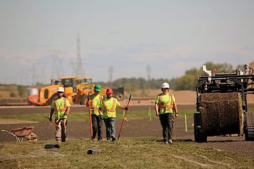 Landscapers lay turf at Brandon's upcoming Maple Leaf Foods Sports Complex where a FIFA-sized soccer pitch is planned. The complex development is in its second phase, involving construction of artificial turf, a lighting system, a scoreboard, bleachers, covered benches and fencing. The work is scheduled to be completed in 2025. (Connor McDowell/Brandon Sun)