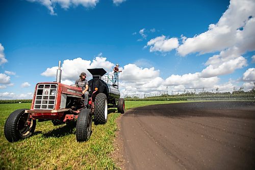 MIKAELA MACKENZIE / WINNIPEG FREE PRESS

Joe Gardiner drives the tractor as Jace Guilford waters the infield at the Field of Dreams baseball diamond near Clearwater, Manitoba on Thursday, Sept. 5, 2024. 

For Mike McIntyre story.
Winnipeg Free Press 2024