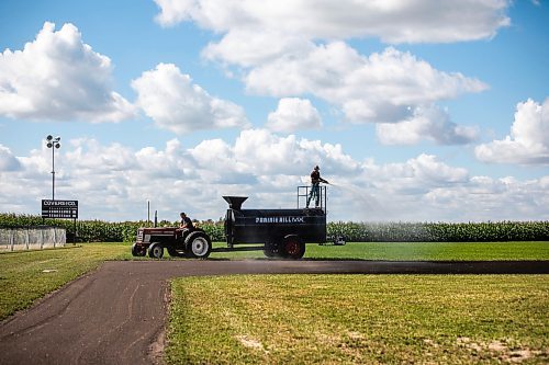 MIKAELA MACKENZIE / WINNIPEG FREE PRESS

Joe Gardiner drives the tractor as Jace Guilford waters the infield at the Field of Dreams baseball diamond near Clearwater, Manitoba on Thursday, Sept. 5, 2024. 

For Mike McIntyre story.
Winnipeg Free Press 2024