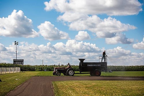 MIKAELA MACKENZIE / WINNIPEG FREE PRESS

Joe Gardiner drives the tractor as Jace Guilford waters the infield at the Field of Dreams baseball diamond near Clearwater, Manitoba on Thursday, Sept. 5, 2024. 

For Mike McIntyre story.
Winnipeg Free Press 2024