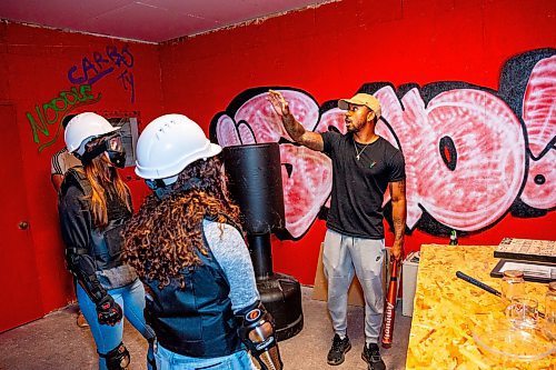 NIC ADAM / FREE PRESS
Owner Tyree Gordon (right) explains the rage rooms rules to Kailey Faith (left) and Alejandra Hurtado, Unleashed Rage Rooms&#x2019; first two official customers, before they break everything from beer bottles to printers Friday.
240906 - Friday, September 06, 2024.

Reporter: Aaron