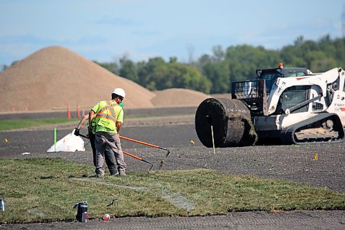 Landscapers lay turf at Brandon's upcoming Maple Leaf Foods Sports Complex where a FIFA-sized soccer pitch is planned. The complex development is in phase 2, involving construction of artificial turf, a lighting system, a scoreboard, bleachers, covered benches and fencing. The work is scheduled to be completed in 2025. (Connor McDowell/Brandon Sun)