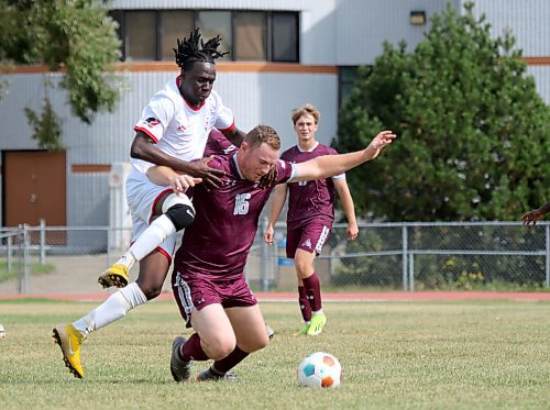 Assiniboine Cougars Stefan McGonigle is fouled during the St. Boniface Les Rouges 9-0 win to open the MCAC men's soccer season at the Sportsplex on Saturday. (Thomas Friesen/The Brandon Sun)