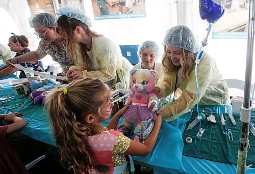 JOHN WOODS / FREE PRESS
Kaitlyn Wiebe, right, and Brynn Arksey, Red River student nurses, patch up Elsa the bear for Reagan at the Teddy Bears&#x2019; Picnic in Assiniboine Park  Sunday, September 8, 2024. 

Reporter: tyler