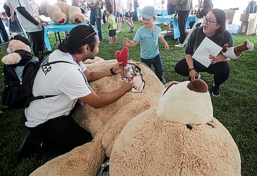 JOHN WOODS / FREE PRESS
Nolan De Leon, medical student, shows internal parts of a bear to Allison McConomy and son Patrick at the Teddy Bears&#x2019; Picnic in Assiniboine Park  Sunday, September 8, 2024. 

Reporter: tyler