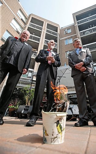 JOHN WOODS / FREE PRESS
Eugene Hyworon, Villa Board president, centre, is joined by board members Rod Noseworthy, left, and Dale Fuga, right,  as they burn the mortgage for St Mary The Protectress Millennium Villa during a community celebration Sunday, September 8, 2024. The  church and senior communities came together to celebrate paying off their villa&#x573; 35 year mortgage.

Reporter: standup