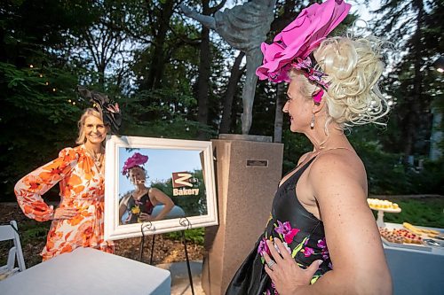 BROOK JONES / FREE PRESS
Chocolate Zen Bakery co-owners Barbara Rudiak (right) who is looking at her reflection in a mirror as Bonnie Greschuk looks on during A Picnic in Provence - Garden Party 2024 at the Leo Mol Sculpture Garden at Assiniboine Park in Winnipeg, Man., Wednesday, Aug. 28, 2024. The annual fundraiser supports the Assiniboine Park Conservancy and this year's event included 500 guests.