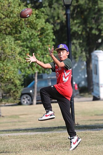 Fifteen-year-old Slater McKay attempts to catch a football thrown by a friend while enjoying the hot sun in Rideau Park after school on Monday afternoon. Temperatures in Brandon reached a high of 32 C on Monday, according to Environment Canada. Expect a similar hot sun today as well, with the temperature expected to hit a high of 32 C by this afternoon. (Matt Goerzen/The Brandon Sun)