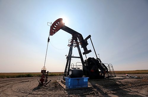 The hot afternoon sun silhouettes an oil pump jack in a field near Elgin on Monday afternoon. (Matt Goerzen/The Brandon Sun)