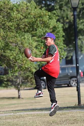 Fifteen-year-old Slater McKay attempts to catch a football thrown by a friend while enjoying the hot sun in Rideau Park after school on Monday afternoon. Temperatures in Brandon reached a high of 32 C on Monday according to Environment Canada. Expect a similar hot sun today as well, with the temperature expected to hit a high of 32 C by Tuesday afternoon. (Matt Goerzen/The Brandon Sun)