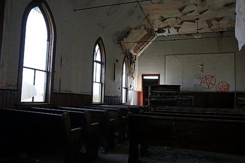 Light flows through empty window frames, illuminating the inside of the decrepit Westbank Memorial Church. (Connor McDowell/Brandon Sun)