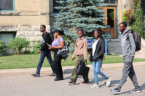 International students at Brandon University walk in front of Clark Hall toward the Knowles Douglas Building on Tuesday. The students are concerned about the federal government's 24-hour weekly work cap, which is set to be implemented this fall. (Abiola Odutola/The Brandon Sun)