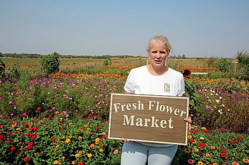 Hazel Thorne stands in her backyard, where she built a garden with rows of different flowers. She started a u-pick flower shop three years ago and says the business is growing. (Connor McDowell/Brandon Sun)