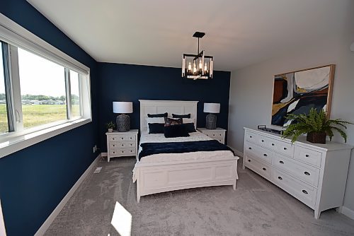 Todd Lewys / Winnipeg Free Press



Tons of natural light flows into the spacious primary bedroom through a huge window on its rear wall, while a midnight blue and grey colour palette creates a calm, relaxing feel.