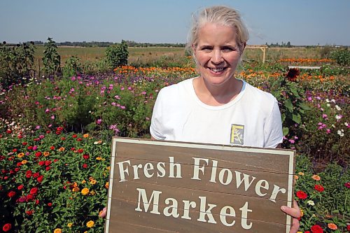 Hazel Thorne stands in her backyard, where she built a garden with rows of different flowers. She started a u-pick flower shop three years ago and says the business is growing. (Connor McDowell/Brandon Sun)