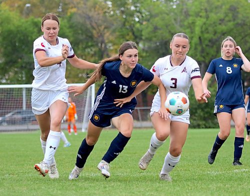 Brandon University striker Jorja Hoad (13) splits a pair of Assiniboine College defenders and scores during their MCAC women's soccer game at the Healthy Living Centre field on Wednesday. (Thomas Friesen/The Brandon Sun)