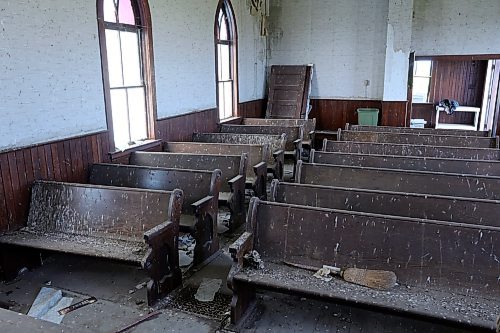 Seats at the Berbank Memorial Church are covered in bird droppings and a pile of doors is stacked in the corner. The doors from the entrance have been ripped off their hinges since a photo showing them attached in 2010. (Connor McDowell/Brandon Sun)