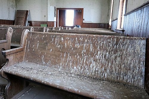 Bird droppings cover seating at the Berbank Memorial Church. A pile of doors sits in the corner, and the entryway seen closed in a photo from 2010 can be seen open as doors have been taken off the hinges. (Connor McDowell/Brandon Sun)