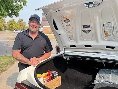 Mike Williams stands beside the massive trunk of his 1987 Buick Regal Limited at his home in Brandon's west end on Wednesday. (Michele McDougall/The Brandon Sun)