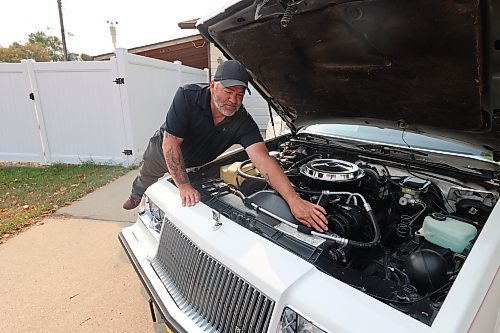 Mike Williams points to the factory-installed radiator hose on his 1987 Buick Regal Limited at his home in Brandon's west end on Wednesday. (Photos by Michele McDougall/The Brandon Sun)