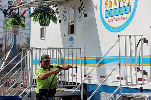 Select Shows president Jim Mills sprays his truck with water in preparation for the 2024 Food Truck Warz at the Keystone Centre on Thursday afternoon. (Abiola Odutola/The Brandon Sun)