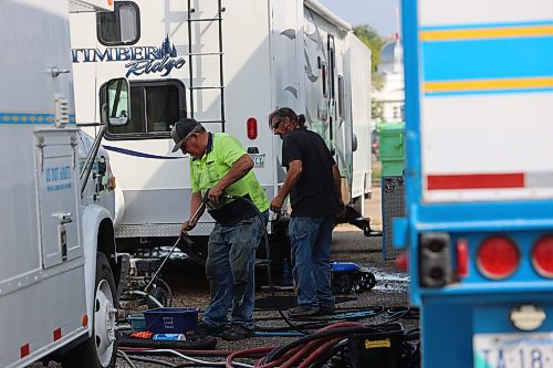 Select Shows president Jim Mills cleans some tools with water in preparation for the 2024 Food Truck Warz at the Keystone Centre on Thursday afternoon. (Abiola Odutola/The Brandon Sun)