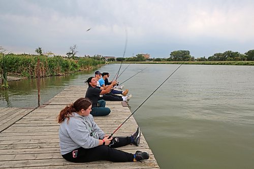 Students from a Brandon University outdoor education course cast fishing lines into the Assiniboine River off of Dinsdale Park on a cloudy Thursday afternoon. (Colin Slark/The Brandon Sun)