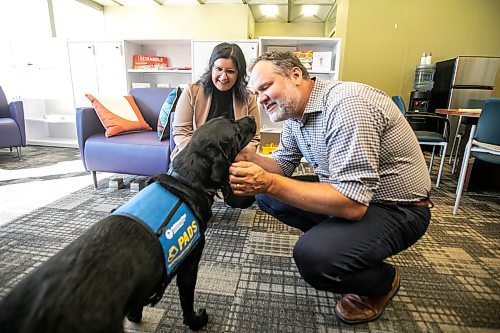 MIKAELA MACKENZIE / WINNIPEG FREE PRESS
	
Justice minister Matt Wiebe greets victim services support dog Gloucester (aka Glossy) with victim services worker Carla Deeley on Monday, Aug. 26, 2024. 

For Nicole story.
Winnipeg Free Press 2024