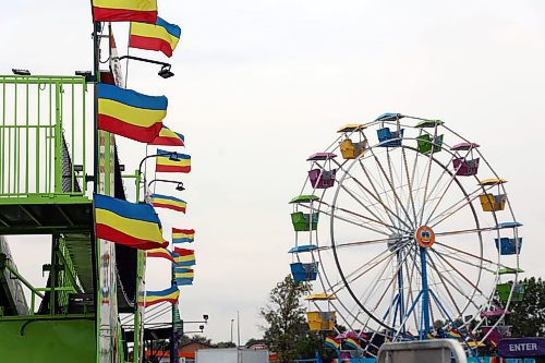 Carnival flags and a ferris wheel are set up near Keystone Centre as a weekend event has come to town. Rides were set to open at 5 p.m. to the public on Friday, and the event will continue through the weekend closing at 10 p.m. on Friday and Saturday, and 6 p.m. on Sunday. (Connor McDowell/Brandon Sun)