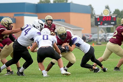 Vincent Massey's defence, including Newman Chikwado (74), Caleb Edwards (0) and Joel Paddock (3) stuff Crocus Plainsmen running back Muqtadir Apena at the three-yard line, the closest Crocus came to scoring in a 21-0 shutout. (Thomas Friesen/The Brandon Sun)